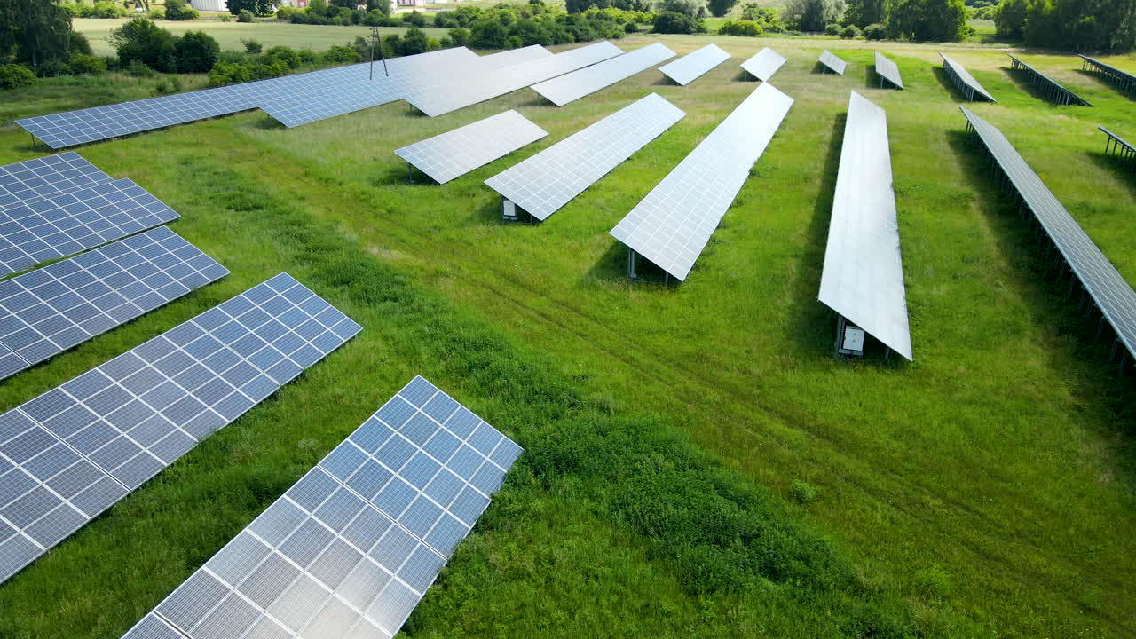 Aerial Shot Of Solar Panels In Renewable Energy Farm In Sunny Green