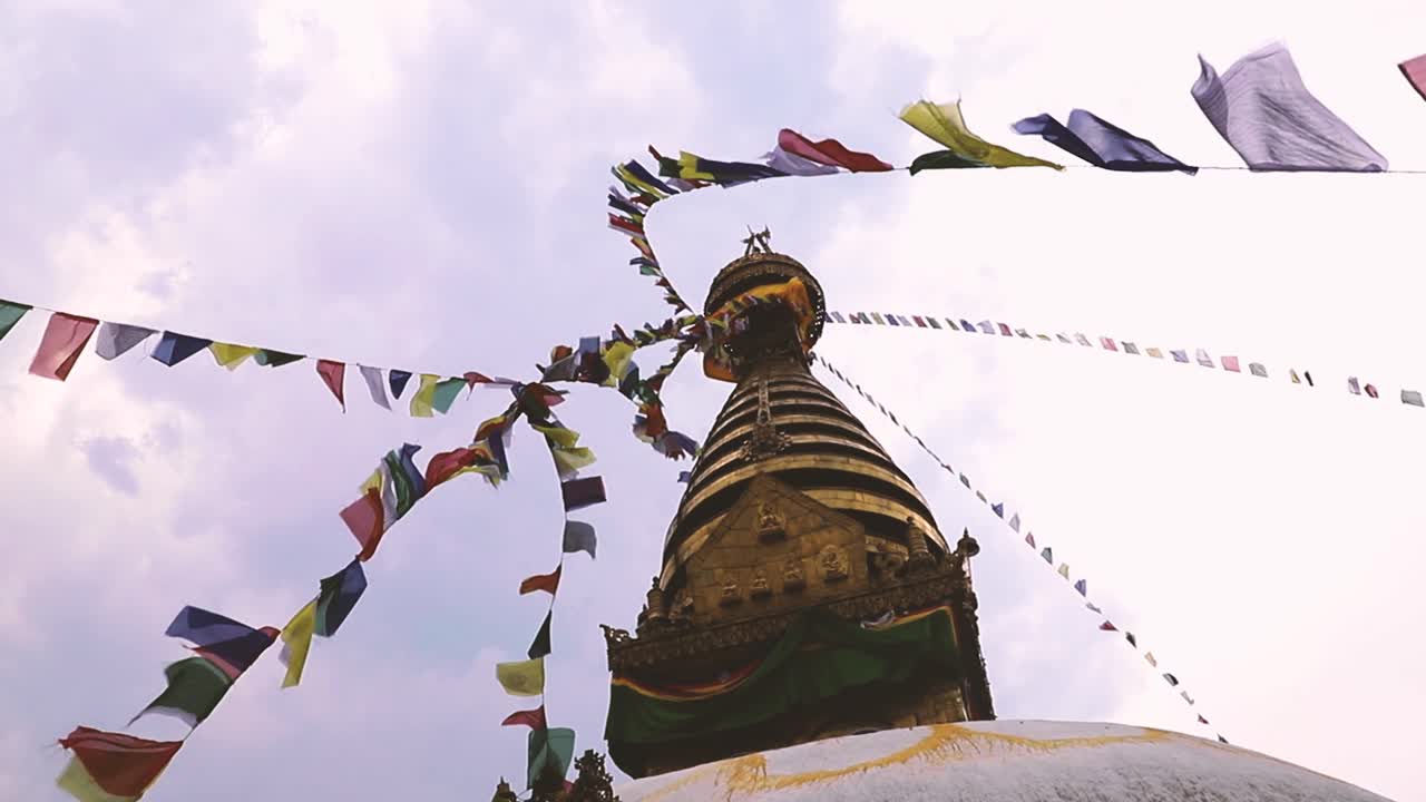 Spire Of The Great Stupa Of Boudhanath Among Of Prayer Flags On A