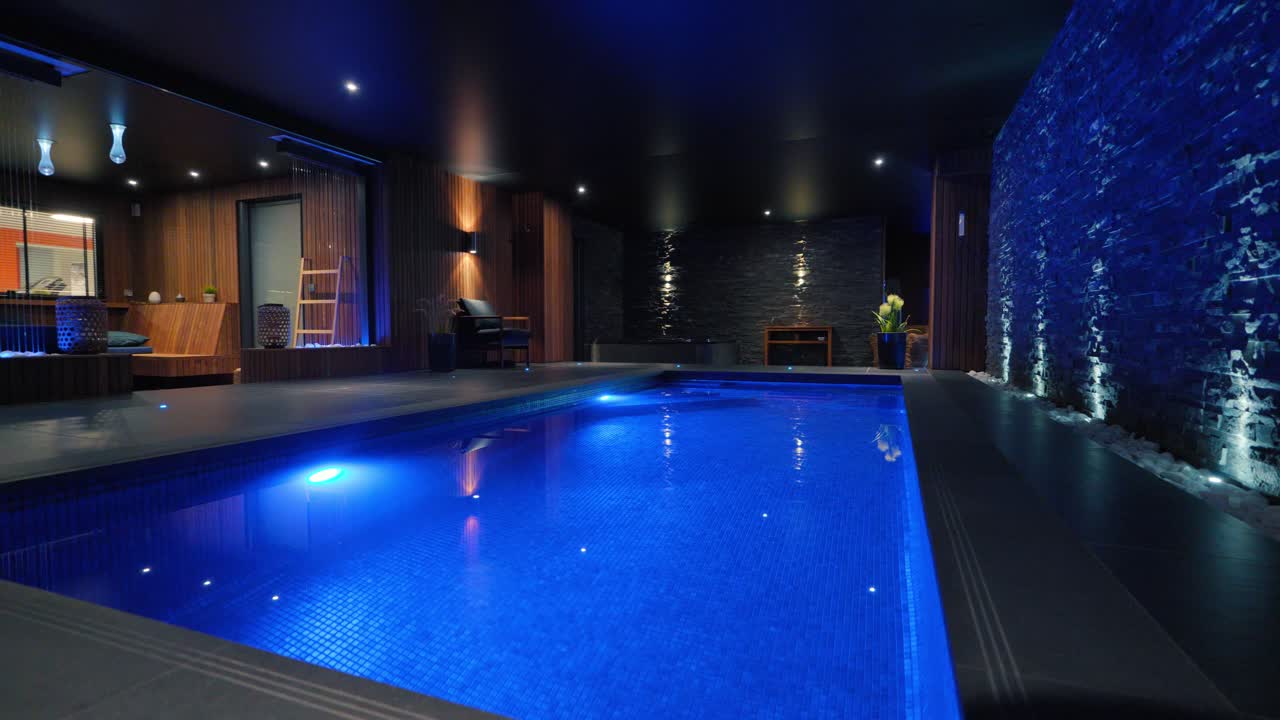 Premium Stock Video Low Orbiting Shot Of An Indoor Pool In A Villa