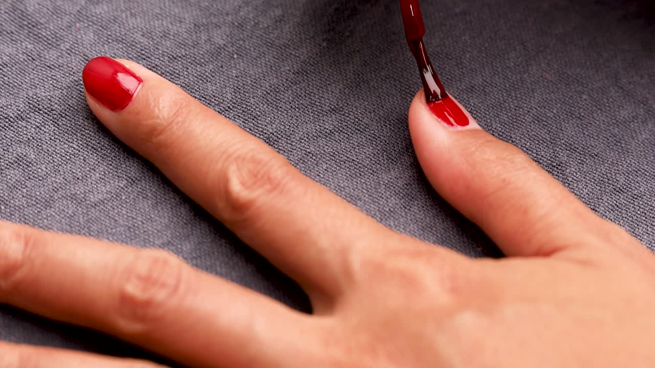 Woman Painting Nails With Red Nail Polish Premium Stock Video Footage