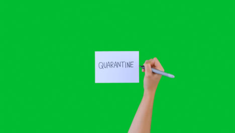 Woman-Writing-Quarantine-on-Paper-with-Green-Screen-01