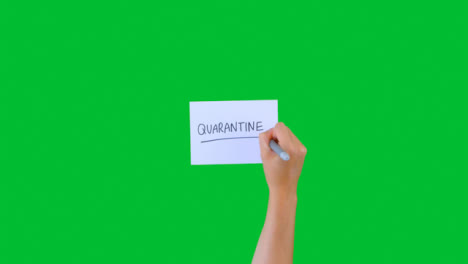 Woman-Writing-Quarantine-on-Paper-with-Green-Screen-02