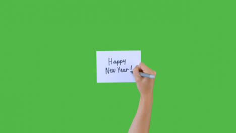Woman-Writing-Happy-New-Year-on-Paper-with-Green-Screen-01