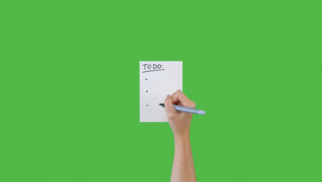 Frau-Schreibt-Aufgaben-Und-Aufzählungspunkte-Auf-Papier-Mit-Grünem-Bildschirm