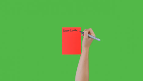 Woman-Writing-Dear-Santa-on-Paper-with-Green-Screen