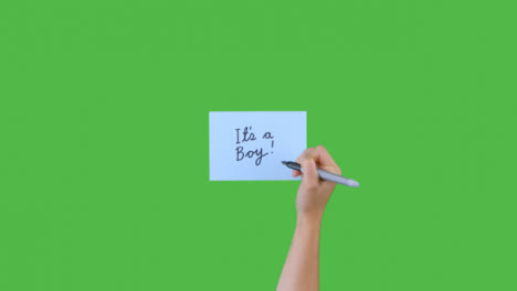 Woman-Writing-Its-a-Boy-on-Paper-with-Green-Screen