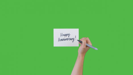 Mujer-Escribiendo-Feliz-Aniversario-En-Papel-Con-Pantalla-Verde