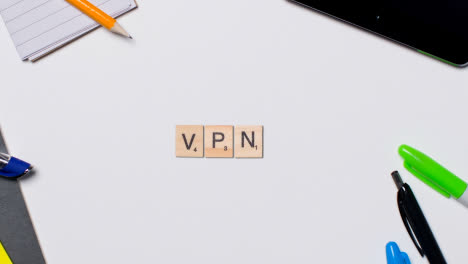 Stop-Motion-Business-Concept-Above-Desk-Wooden-Letter-Tiles-Forming-Acronym-VPN