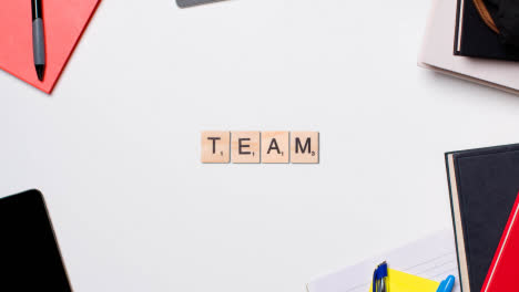 Stop-Motion-Business-Concept-Above-Desk-Wooden-Letter-Tiles-Forming-Word-Team