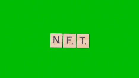 Stop-Motion-Business-Concept-Overhead-Shot-Wooden-Letter-Tiles-Forming-Acronym-NFT-On-Green-Screen-1