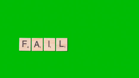 Stop-Motion-Business-Concept-Overhead-Wooden-Letter-Tiles-Forming-Word-Fail-On-Green-Screen-1