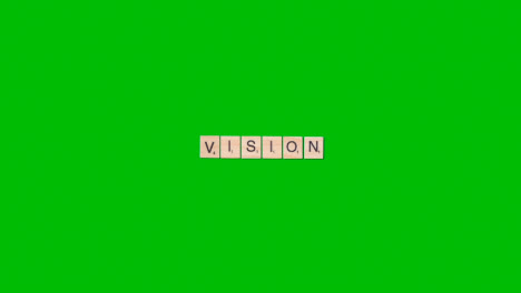 Stop-Motion-Business-Concept-Overhead-Wooden-Letter-Tiles-Forming-Word-Vision-On-Green-Screen