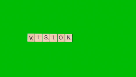 Stop-Motion-Business-Concept-Overhead-Wooden-Letter-Tiles-Forming-Word-Vision-On-Green-Screen-1