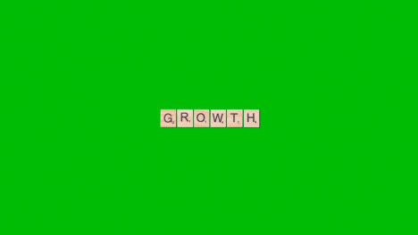 Stop-Motion-Business-Concept-Overhead-Wooden-Letter-Tiles-Forming-Word-Growth-On-Green-Screen