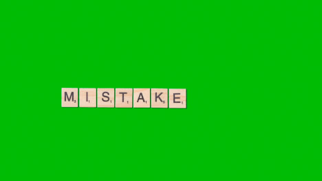 Stop-Motion-Business-Concept-Overhead-Wooden-Letter-Tiles-Forming-Word-Mistake-On-Green-Screen-1