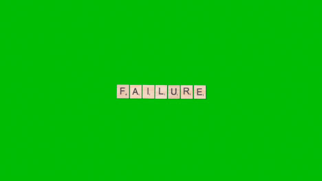 Stop-Motion-Business-Concept-Overhead-Wooden-Letter-Tiles-Forming-Word-Failure-On-Green-Screen