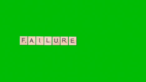 Stop-Motion-Business-Concept-Overhead-Wooden-Letter-Tiles-Forming-Word-Failure-On-Green-Screen-1