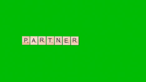 Stop-Motion-Business-Concept-Overhead-Wooden-Letter-Tiles-Forming-Word-Partner-On-Green-Screen-1