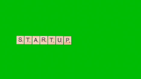 Stop-Motion-Business-Concept-Overhead-Wooden-Letter-Tiles-Forming-Word-Startup-On-Green-Screen-1