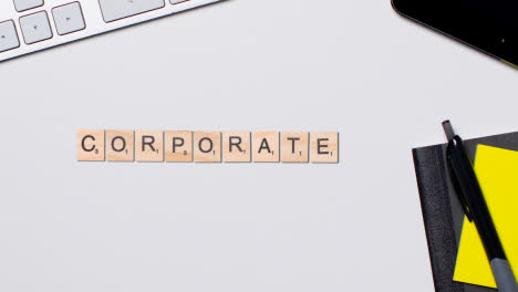 Stop-Motion-Business-Concept-Above-Desk-Wooden-Letter-Tiles-Forming-Word-Corporate-1