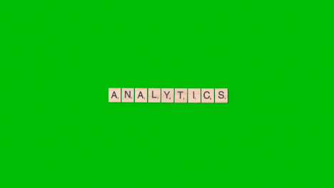 Stop-Motion-Business-Concept-Overhead-Wooden-Letter-Tiles-Forming-Word-Analytics-On-Green-Screen