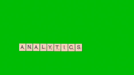 Stop-Motion-Business-Concept-Overhead-Wooden-Letter-Tiles-Forming-Word-Analytics-On-Green-Screen-1