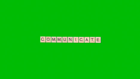 Stop-Motion-Business-Concept-Overhead-Wooden-Letter-Tiles-Forming-Word-Communicate-On-Green-Screen
