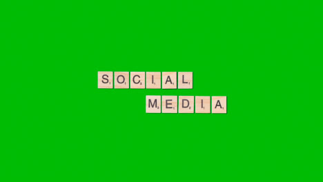 Stop-Motion-Business-Concept-Overhead-Wooden-Letter-Tiles-Forming-Words-Social-Media-On-Green-Screen