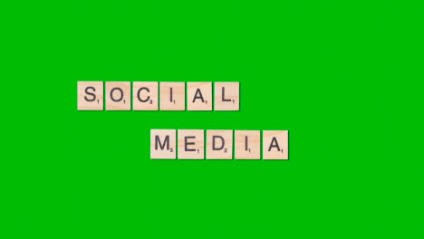 Stop-Motion-Business-Concept-Overhead-Wooden-Letter-Tiles-Forming-Words-Social-Media-On-Green-Screen-1