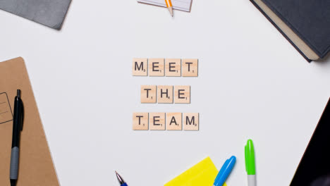 Stop-Motion-Business-Concept-Above-Desk-Wooden-Letter-Tiles-Forming-Words-Meet-The-Team-1