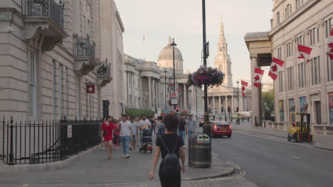 Trafalgar-Square-With-National-Gallery-St-Martin-In-The-Fields-Church-And-Canadian-Embassy-With-Tourists-In-London-England-UK