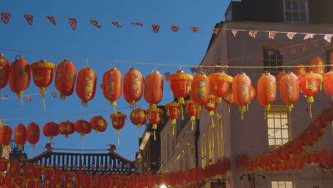 Close-Up-Of-Paper-Lanterns-Across-Gerrard-Street-In-Chinatown-At-Dusk-In-London-England-UK