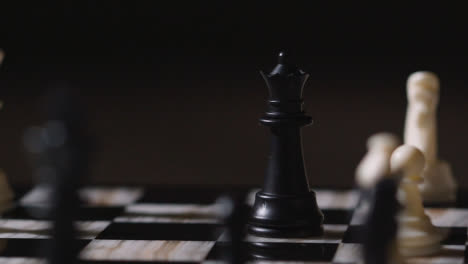 Studio-Shot-Chess-Board-And-Pieces-Set-Up-For-Game-With-Player-Taking-White-Queen