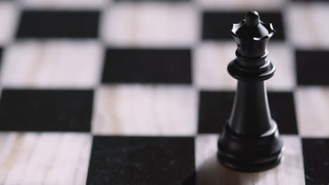 Studio-Shot-Chess-Board-With-Camera-Tracking-And-Stopping-On-Black-Queen-Piece