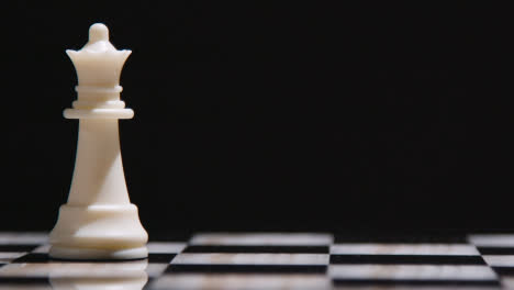 Studio-Shot-Chess-Board-With-Camera-Tracking-And-Stopping-On-White-Queen-Piece