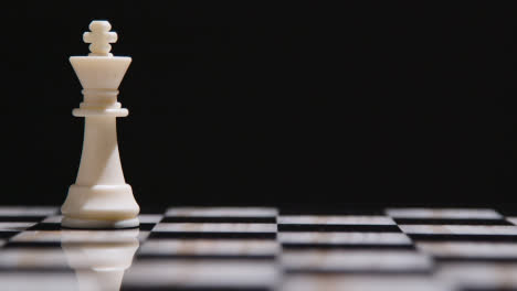 Studio-Shot-Chess-Board-With-Camera-Tracking-And-Stopping-On-White-King-Piece