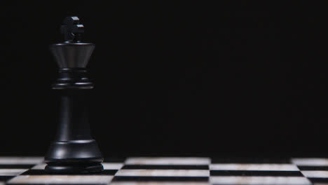 Studio-Shot-Chess-Board-With-Camera-Tracking-And-Stopping-On-Black-King-Piece