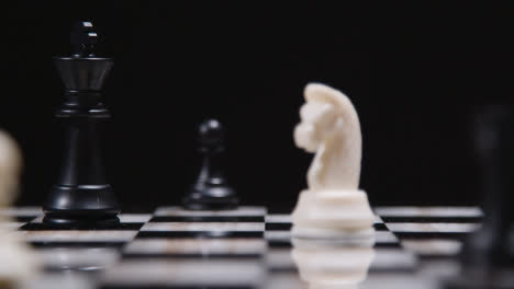 Studio-Shot-Chess-Board-And-Pieces-Set-Up-For-Game-With-Player-Taking-Black-King