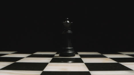 Studio-Shot-Of-Chess-Board-Empty-Apart-From-Black-Queen-Piece