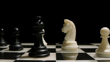 Studio-Shot-Chess-Board-And-Pieces-Set-Up-For-Game-With-Black-Bishop-Taking-White-Knight
