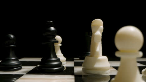 Studio-Shot-Chess-Board-And-Pieces-Set-Up-For-Game-With-White-Bishop-Taking-Black-Bishop