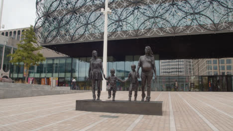 Exterior-Of-Modern-Building-And-Statue-Of-Family-In-Centenary-Square-In-Birmingham-UK-1