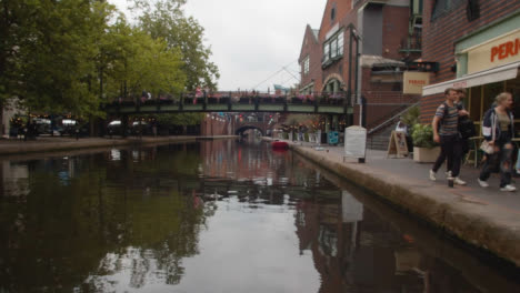 View-From-Canal-Boat-With-Tourists-At-Brindley-Place-In-Birmingham-UK