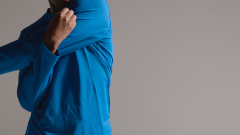 Studio-Shot-Of-Young-Male-Footballer-Warming-Up-With-Stretches-Before-Game-3