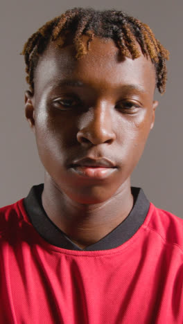 Vertical-Video-Portrait-Of-Young-Male-Footballer-Or-Sportsperson-Wearing-Club-Kit