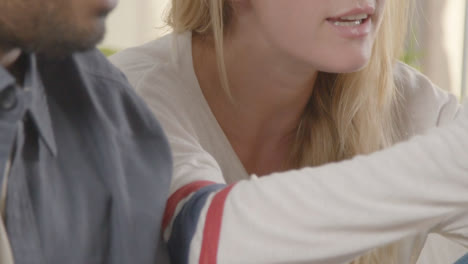 Close-Up-Of-Disappointed-Multi-Cultural-Friends-Watching-Sports-Game-On-TV-Sitting-On-Sofa-At-Home-Together-1