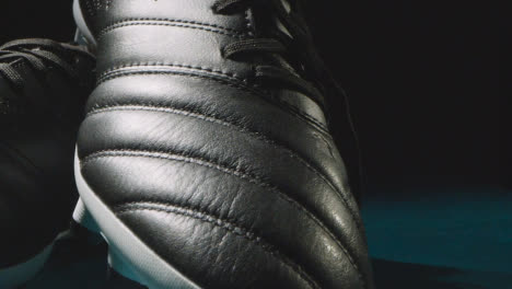 Studio-Still-Life-Shot-Of-Football-Soccer-Boots-Against-Black-Background-3