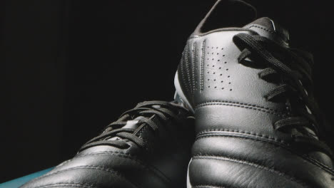 Studio-Still-Life-Shot-Of-Football-Soccer-Boots-Against-Black-Background-4