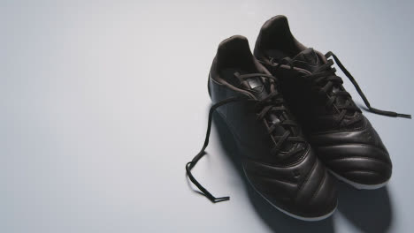 Studio-Still-Life-Shot-Of-Football-Soccer-Boots-Against-White-Background