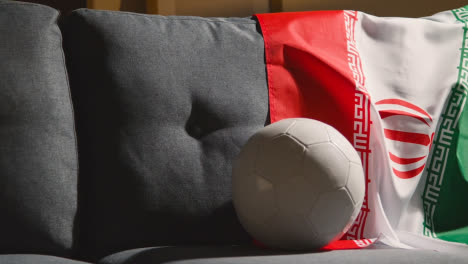 Sofa-In-Lounge-With-Iranian-Flag-And-Ball-As-Fans-Prepare-To-Watch-Football-Soccer-Match-On-TV-1